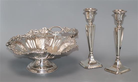 A pair of George V silver candlesticks (a.f.) and a plated cake basket height 22cm